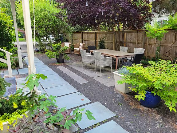 Our garden/back yard with outdoor patio furniture for the summer. In the distance the South Geneva St. driveway