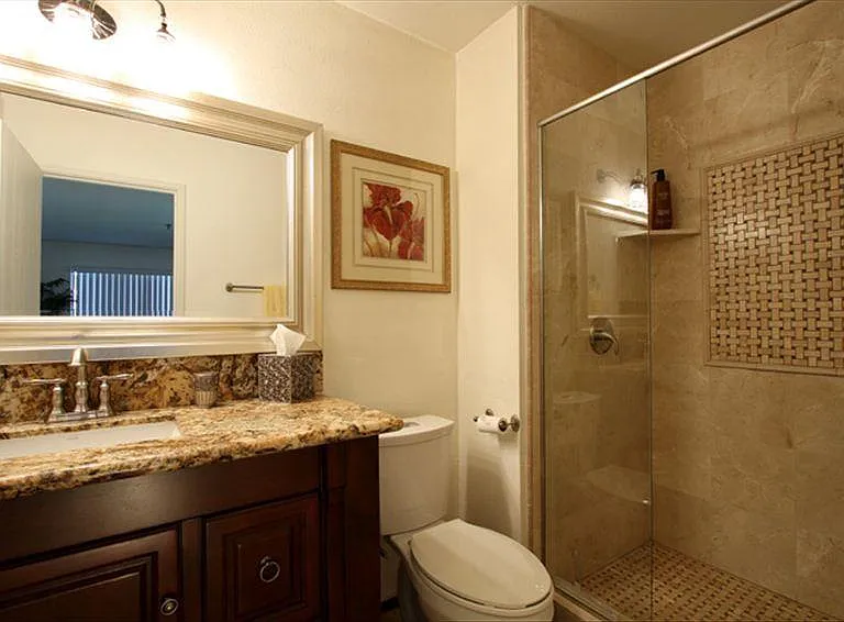 Stone tiled walk-in shower adjoined to the master.