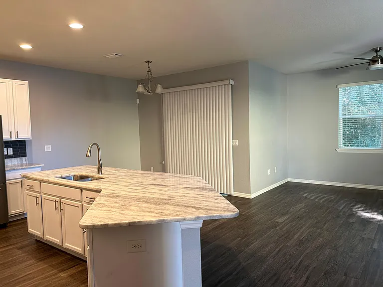 Kitchen lover looking dining room, living room and views to private backyard