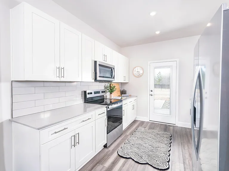 Creating culinary magic in this spacious kitchen complete with stainless steel appliances.