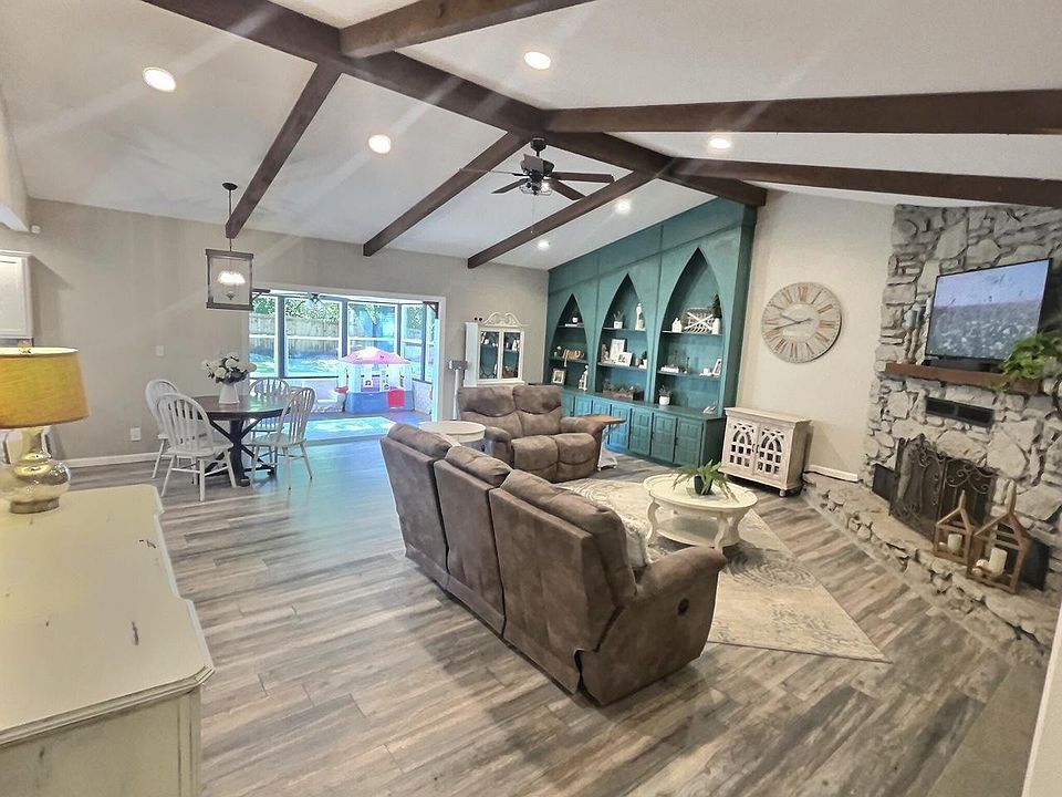 Living Room with vaulted ceilings, sunroom to patio
