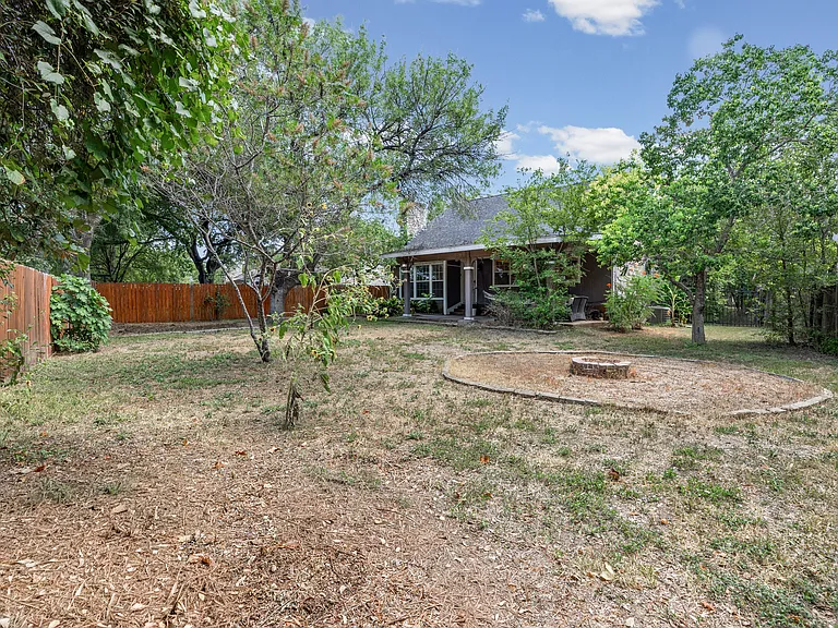 Large backyard with a fire pit, storage shed, and space for garden boxes if you wish! The other half of the yard is shaded by a large oak tree.