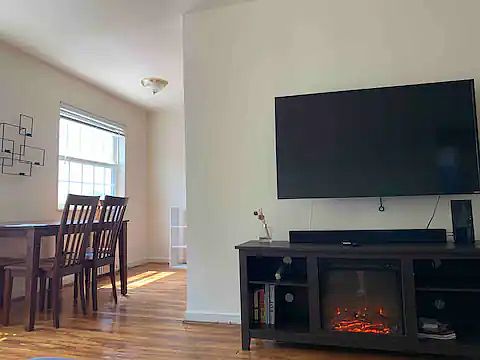 Living / dining room with 50", smart television and fireplace