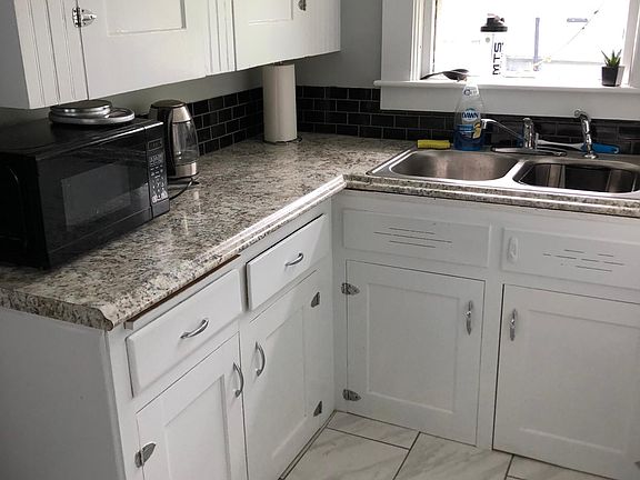 freshly painted wooden cabinets and plenty of light to prepare dinner