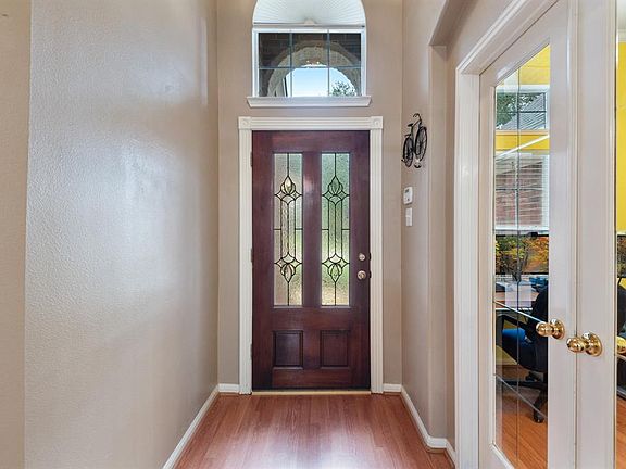Beautiful beveled glass front door. To the right are the French doors leading to your private study.