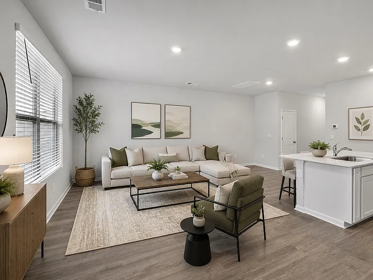 Virtually staged image. The open-concept living room and kitchen are located in the rear of the house, allowing for maximum privacy.