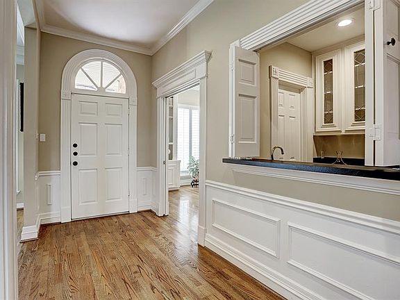The large foyer opens into the first floor living area, study and dining room creating an open flow between the living and dining areas. It is complimented by a wet bar facing the living room.