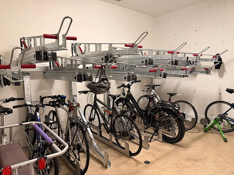 Well-maintained, locked bike storage room offering a clean and secure space to store your bicycles.