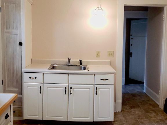 Kitchen: Laminate flooring; Tons of cabinet space; Includes refrigerator; oven and over head vent. Also has access to rear deck.