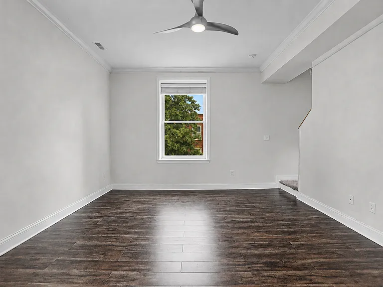 Another view of the spacious first-floor family room, featuring 10-foot ceilings, a flexible layout, and convenient access to the second floor.