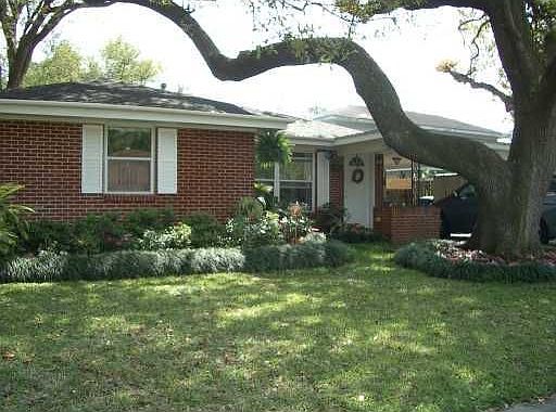 Beautiful perennial garden surrounds the front of the home.