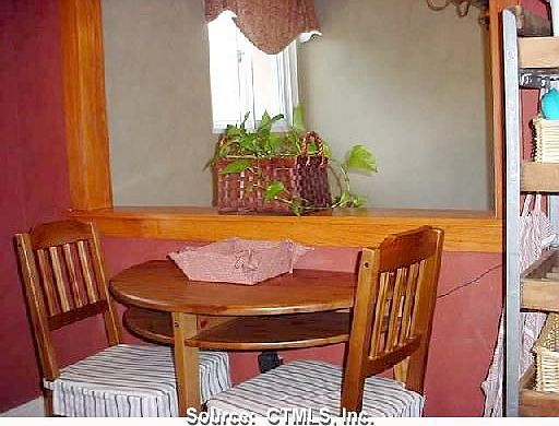 Kitchen table is near the window and an overlook to the foyer entry