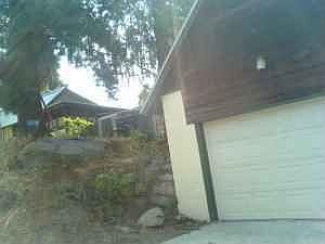 View of garage with in-law apartment above...view up to house and rear dek