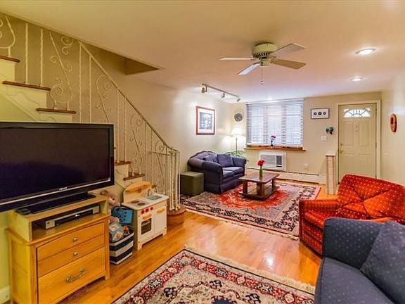 Open floor plan in the living room, a/c and traditional hardwood floors.
