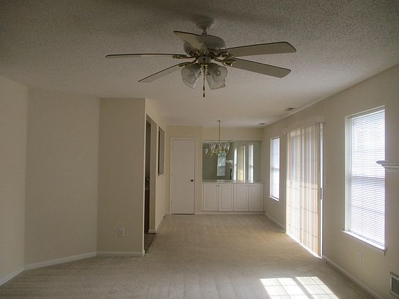 Dining area with extra cabinet storage and sliding glass door that leads to private fenced in patio!
