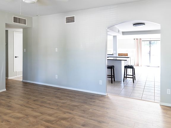 Front/entry room with new flooring and open layout with access to bedrooms down hall and kitchen.