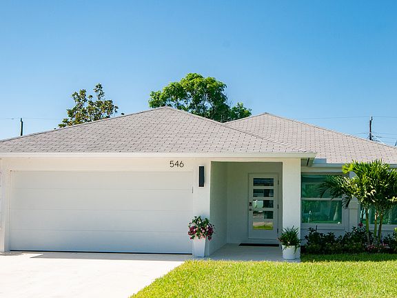 Luxurious modern beach house on the desirable south side of the street in the 500 block of popular Naples Park.