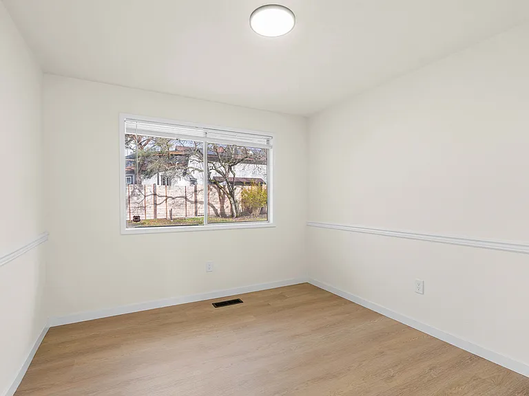 Good-sized room ideal for an office or bonus space, overlooking the beautifully landscaped backyard.