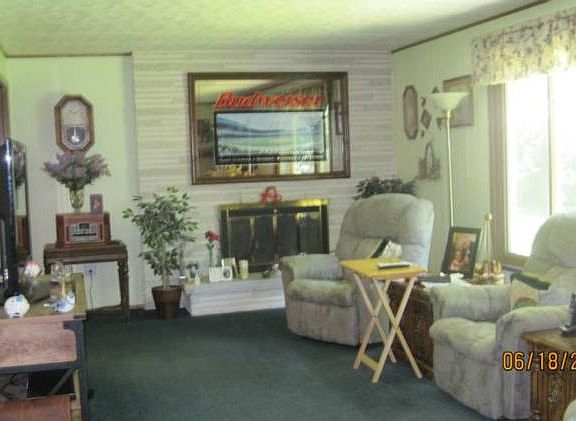 Living room with gas log fireplace.