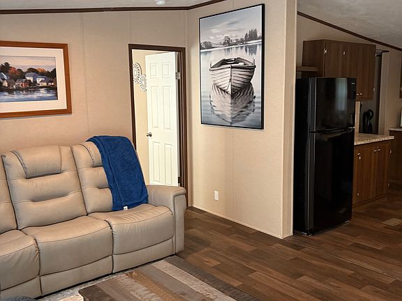 Living room showing Master bedroom door. Kitchen to the right
