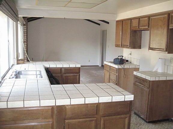 Breakfast nook, kitchen and family room with beamed ceiling