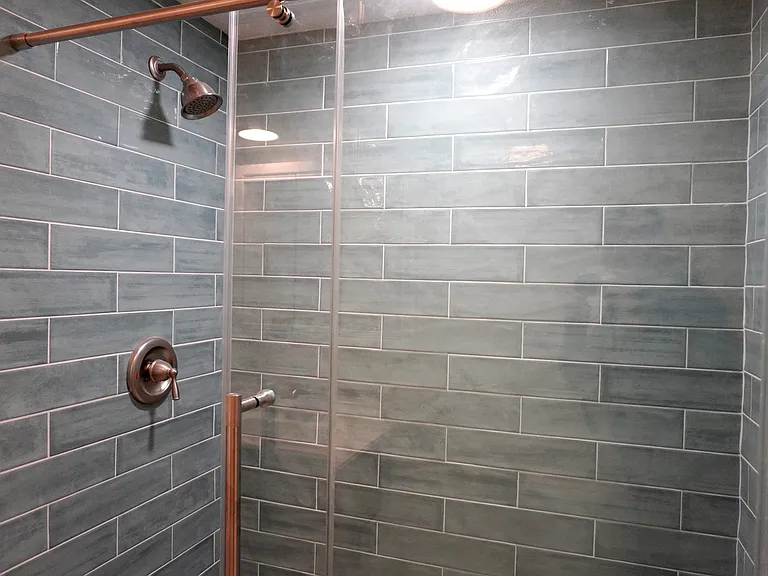 Custom tile shower with stunning glass doors. Resort spa experience shower.