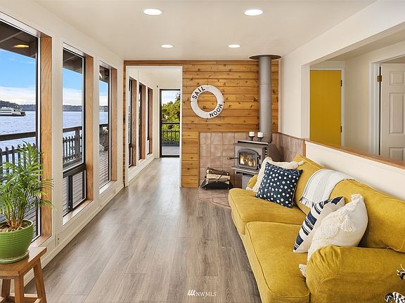 Living room with wrap around deck and view of the ferry. *Current furnishing different from pictures*