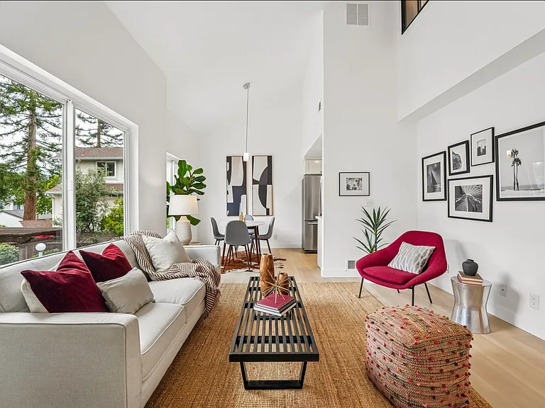 Living room with high ceilings and abundant sunlight