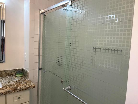 newer subway tiles shower with upgraded fixtures.