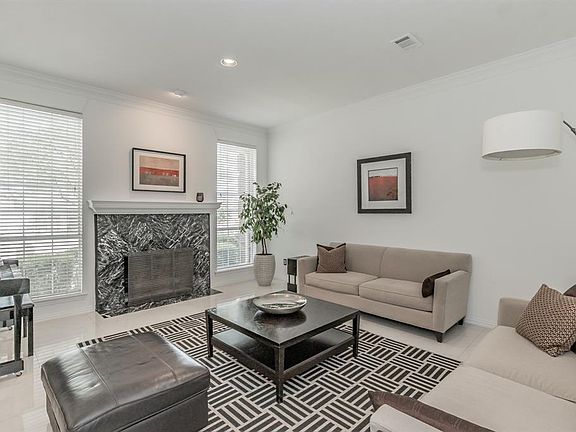 Formal living area features a gas fireplace.