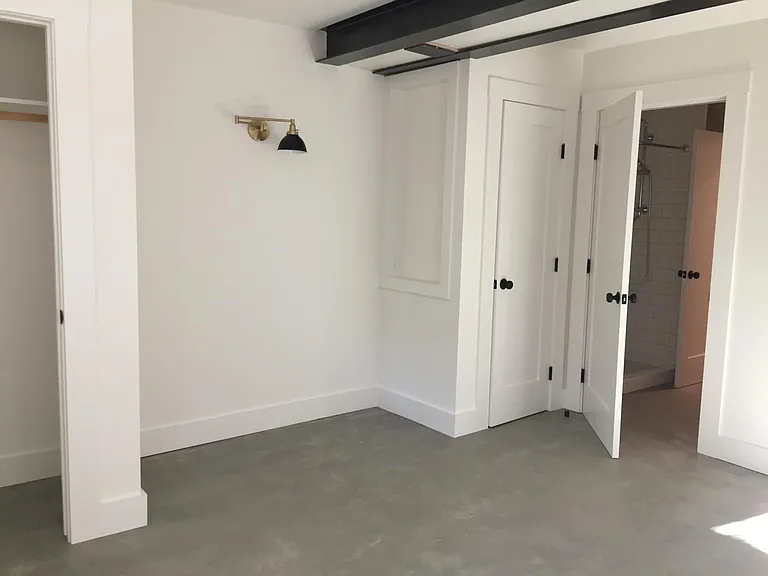 Another view of the bedroom showing two closets and door from the bedroom to the bathroom (note the bathroom is also accessible from the hallway).