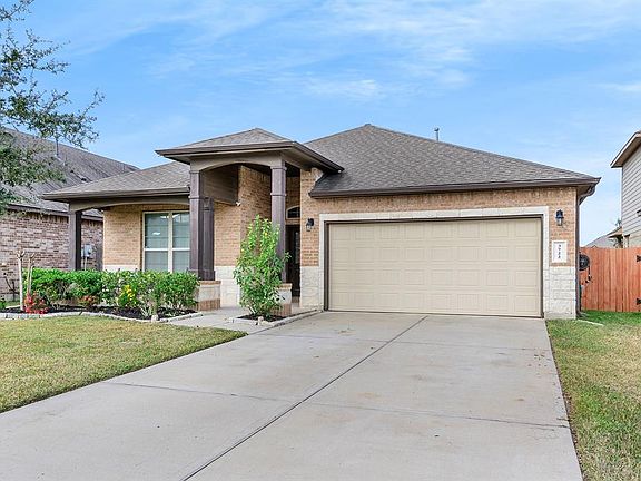 Beautiful landscaping and large front porch with attached 2 car garage.