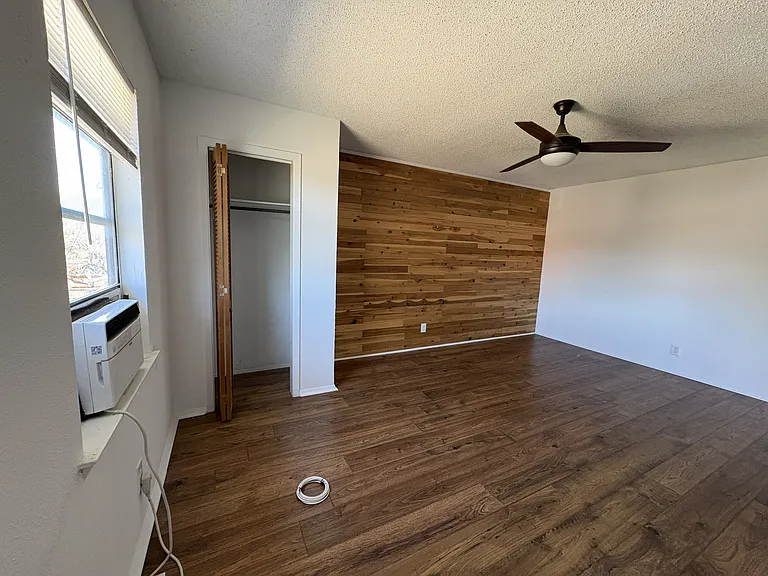 Primary bedroom (upstairs) with beautiful feature wall