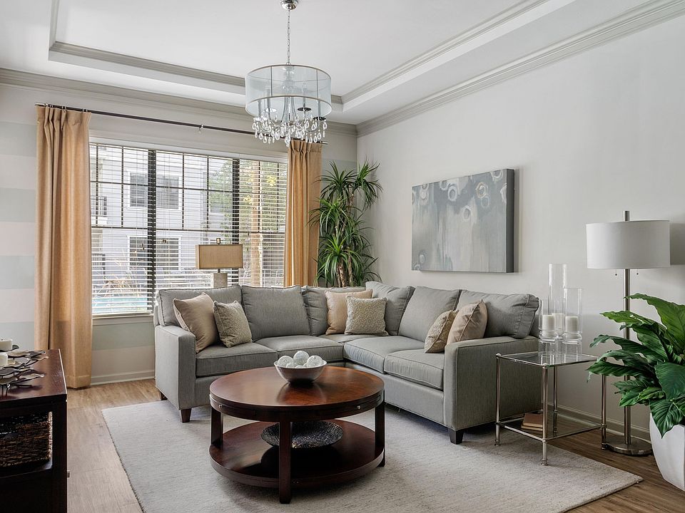 Step into this elegantly designed living room, where comfort meets chic modernity.