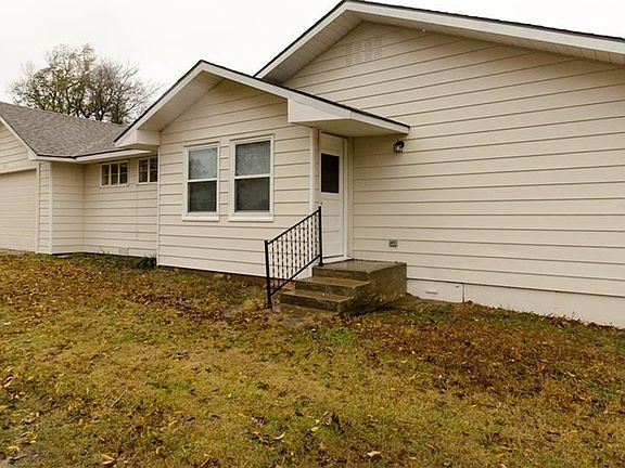 A good view of the side porch and the two car attached garage.  You can see what a large yard it is - stretching all the way back to the fence.  Just over a third of an acre.