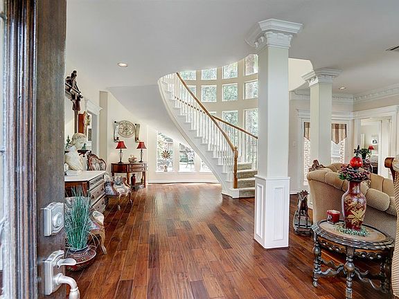 Entering this classic Champions Forest foyer with it's GRAND staircase following the curve of the two story windows is breathtaking!