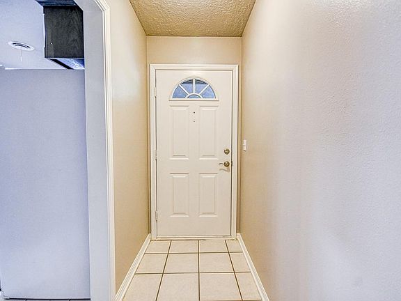 Front entry door with kitchen on left