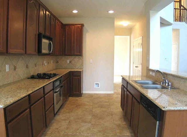 Cherry Wood Cabinets, Granite Open to Living Room 
