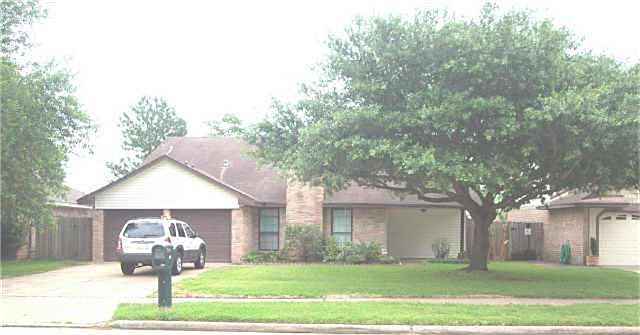 Large shade tree in front yard and nice covered porch.