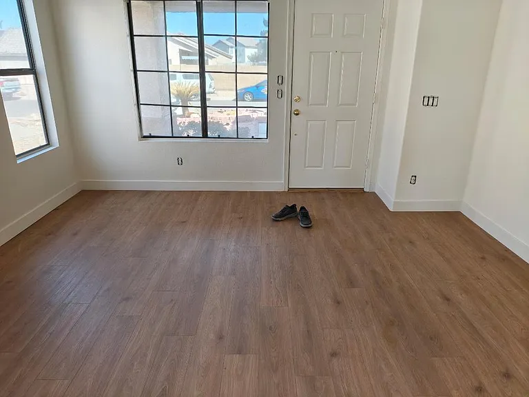 Main living room with all new paint on ceiling and walls. 5 New matching ceiling fans added and outlets being replaced 6/6/26