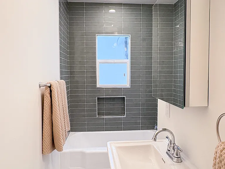 Full bath with original 1950s tub and new tile