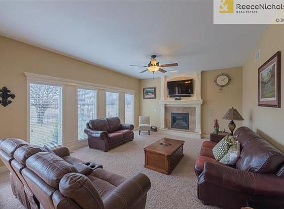 Family room with gas fireplace.  Very private with great natural light and view of green space.