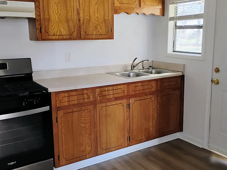 Kitchen with new vinyl flooring. Stainless steel stove only a couple years old