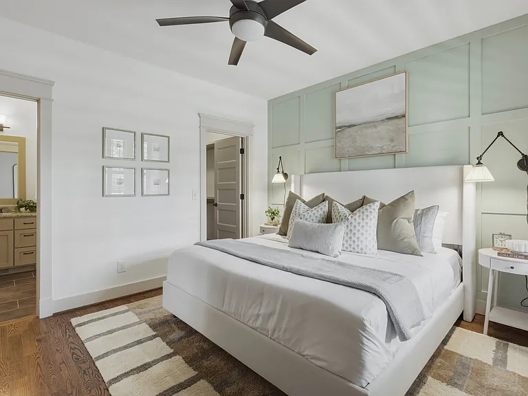 King sized bed in bedroom 2, featuring a walk-in closet, dresser, smart TV, full-length mirror, and ensuite bathroom.