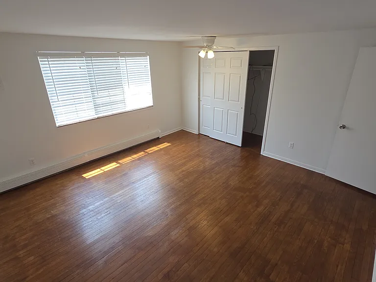 Primary bedroom with ample floor space and wide closet.