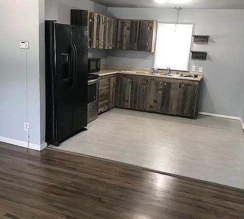 Stylish kitchen cabinets. Refrigerator, microwave, new kitchen faucet and disposal