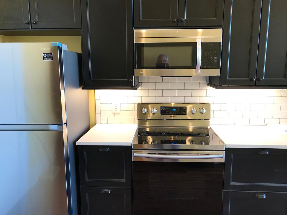 Built in stainless microwave hood, Samsung range and fridge with ice. Cabinets feature drawer in a drawer. quartz countertops.