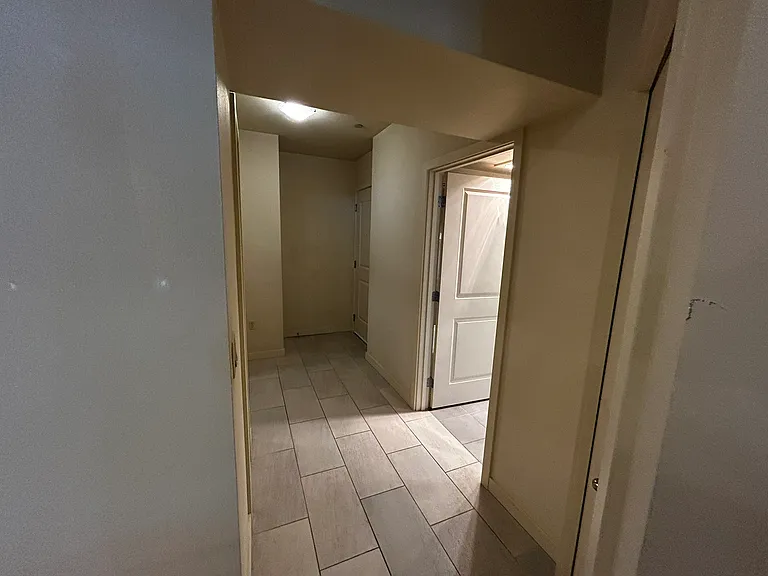 Hallway towards back door and garage. Bathroom entrance to the right.