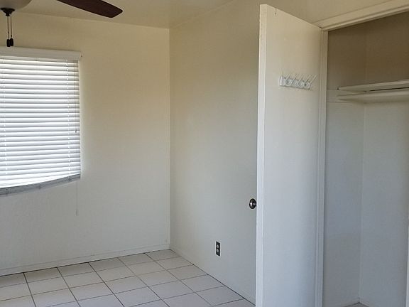 Another angle of the living room taken from the front door of the apartment. The living room has small closet.
