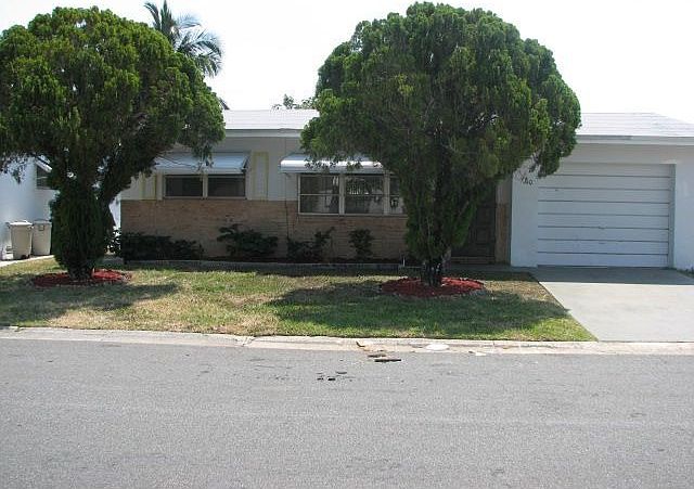 Front of house with lots of trees